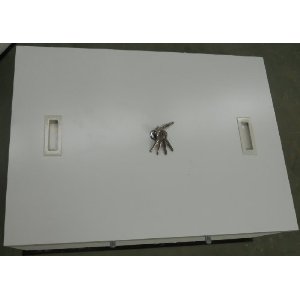 Keys lying on white surface with two rectangular fixtures visible.