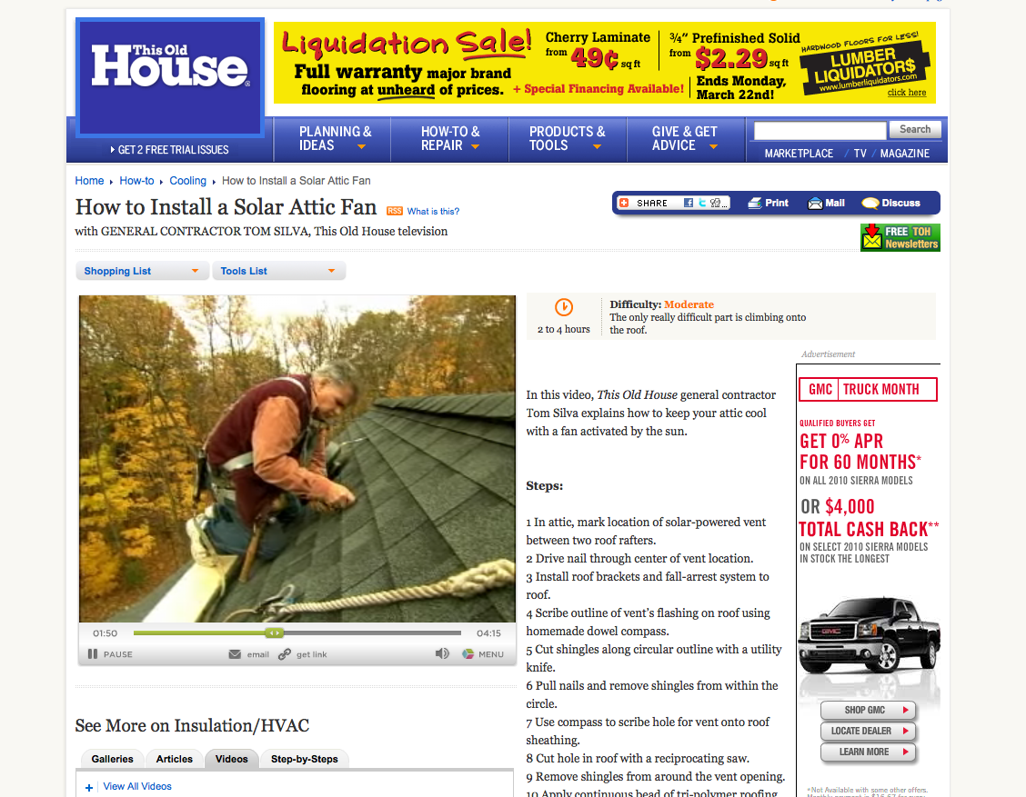 Contractor installing solar-powered attic fan on shingled roof with autumn trees in background.