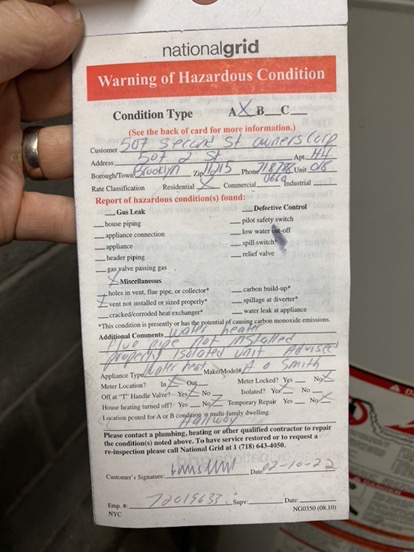 Handwritten National Grid warning of hazardous condition form with checkboxes and inspection details