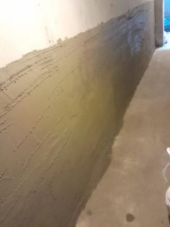Drywall joint compound application on wall seams during renovation.